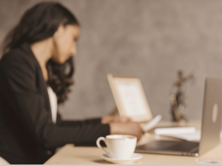 Woman doing a holistic therapy session on a laptop while working in their Los Angeles office.