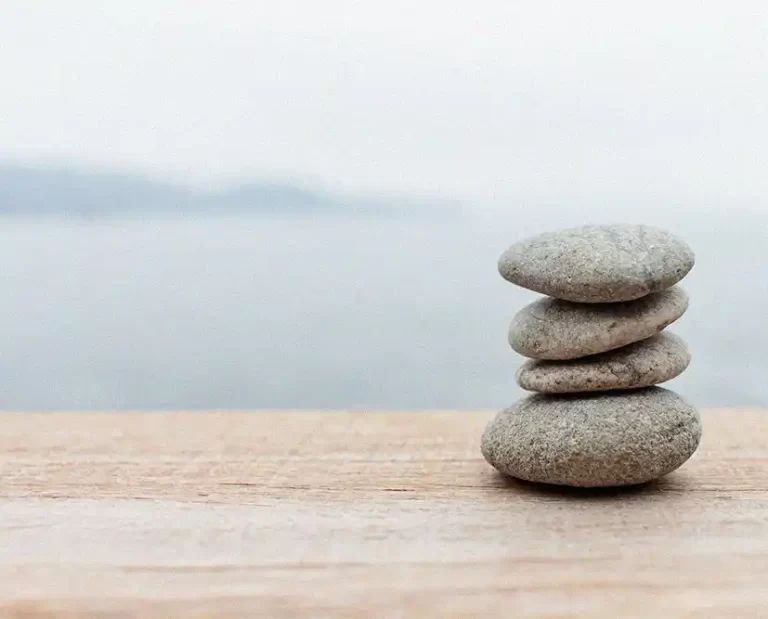 Los angeles therapy in nature. 4 rocks stacked, ocean in background