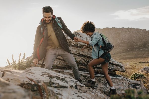 Couple hiking together over rocky terrain in Griffith Park— symbolizing support in anxiety therapy Los Angeles