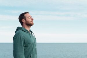 Man on Los Angeles beach reflecting on social anxiety and anxiety therapy Los Angeles