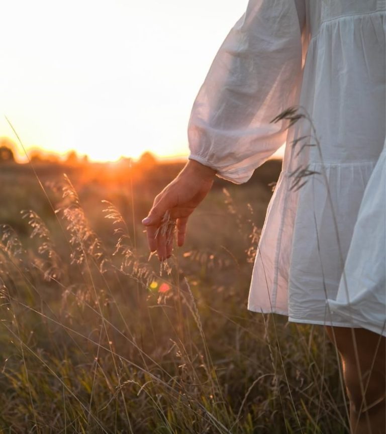 Woman walking through a Los Angeles field during inner child therapy and somatic healing