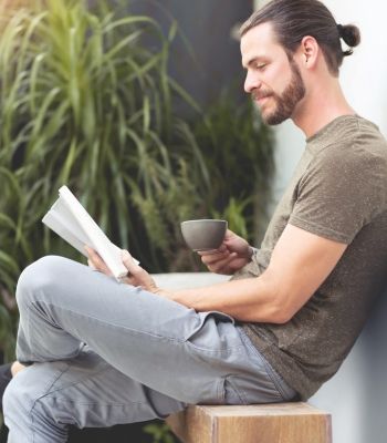 Man reading about somatic therapy in a holistic setting in Los Angeles
