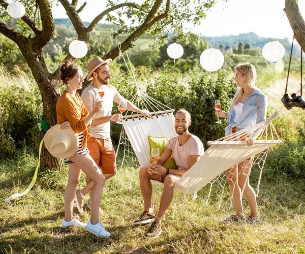 A group of friends enjoying an outdoor gathering with hammocks, symbolizing the joy and emotional reconnection achieved through somatic and trauma therapy in Los Angeles.