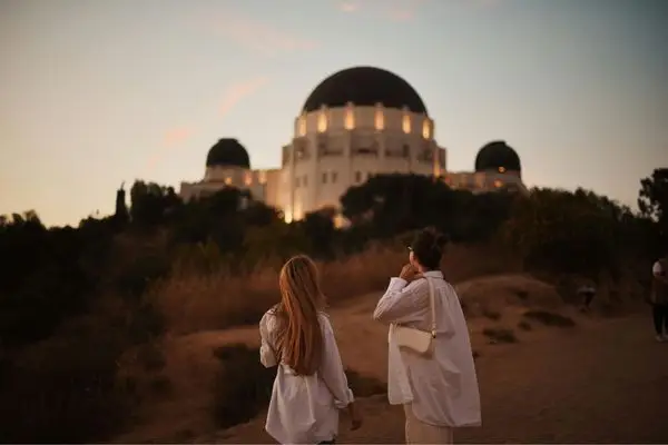 Two women walking near Griffith Observatory in Los Angeles, symbolizing connection after IFS therapy
