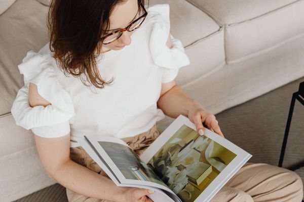 Person sitting comfortably indoors while reading, showing rest and low-demand support during stress