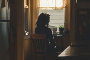 Woman experiencing dorsal vagal shutdown sitting quietly, somatic therapy Los Angeles