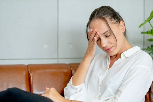 Woman showing signs of hypervigilance — tension and overwhelm in the nervous system